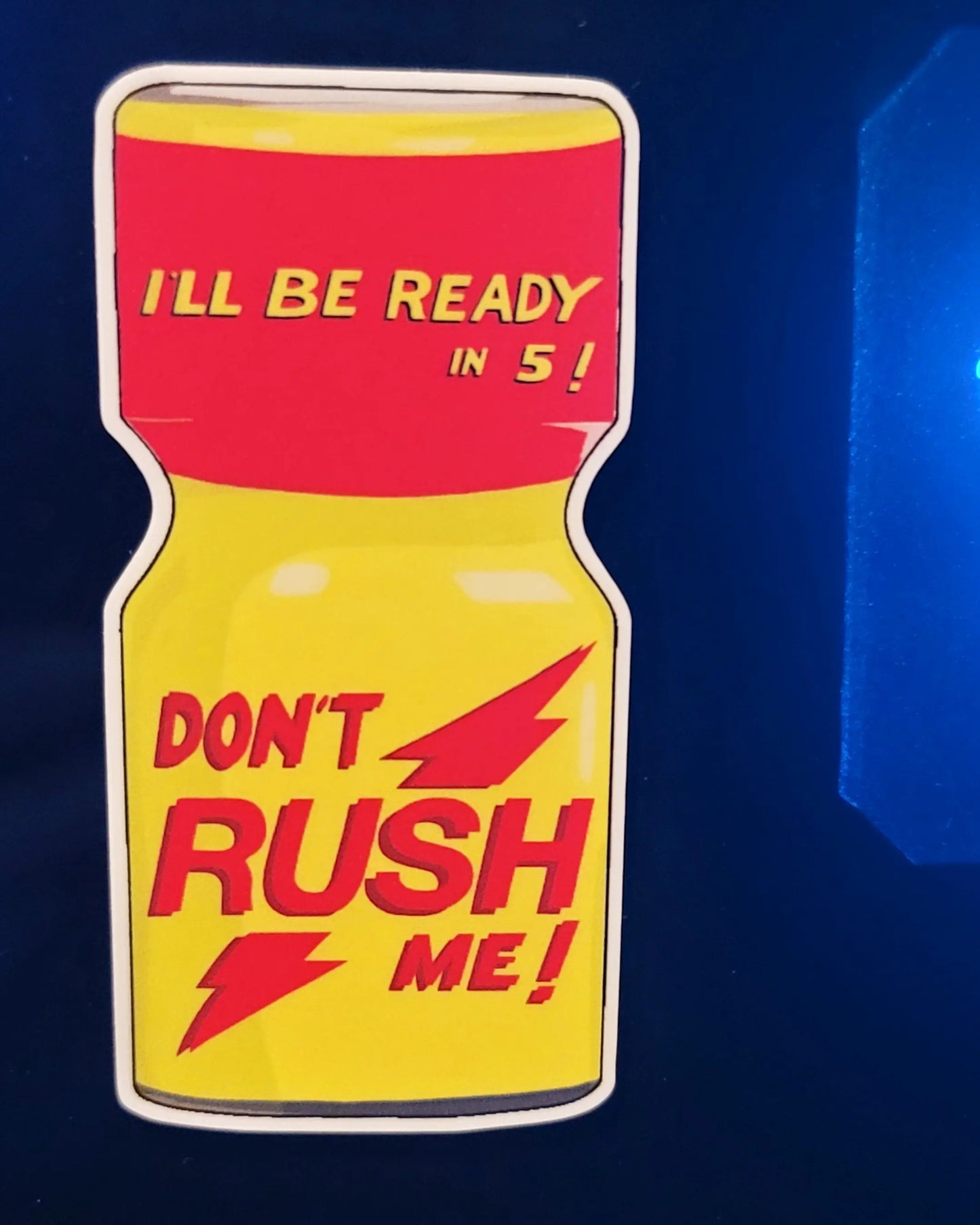 "Don't rush me" sticker applied to surface with blue glow behind it.