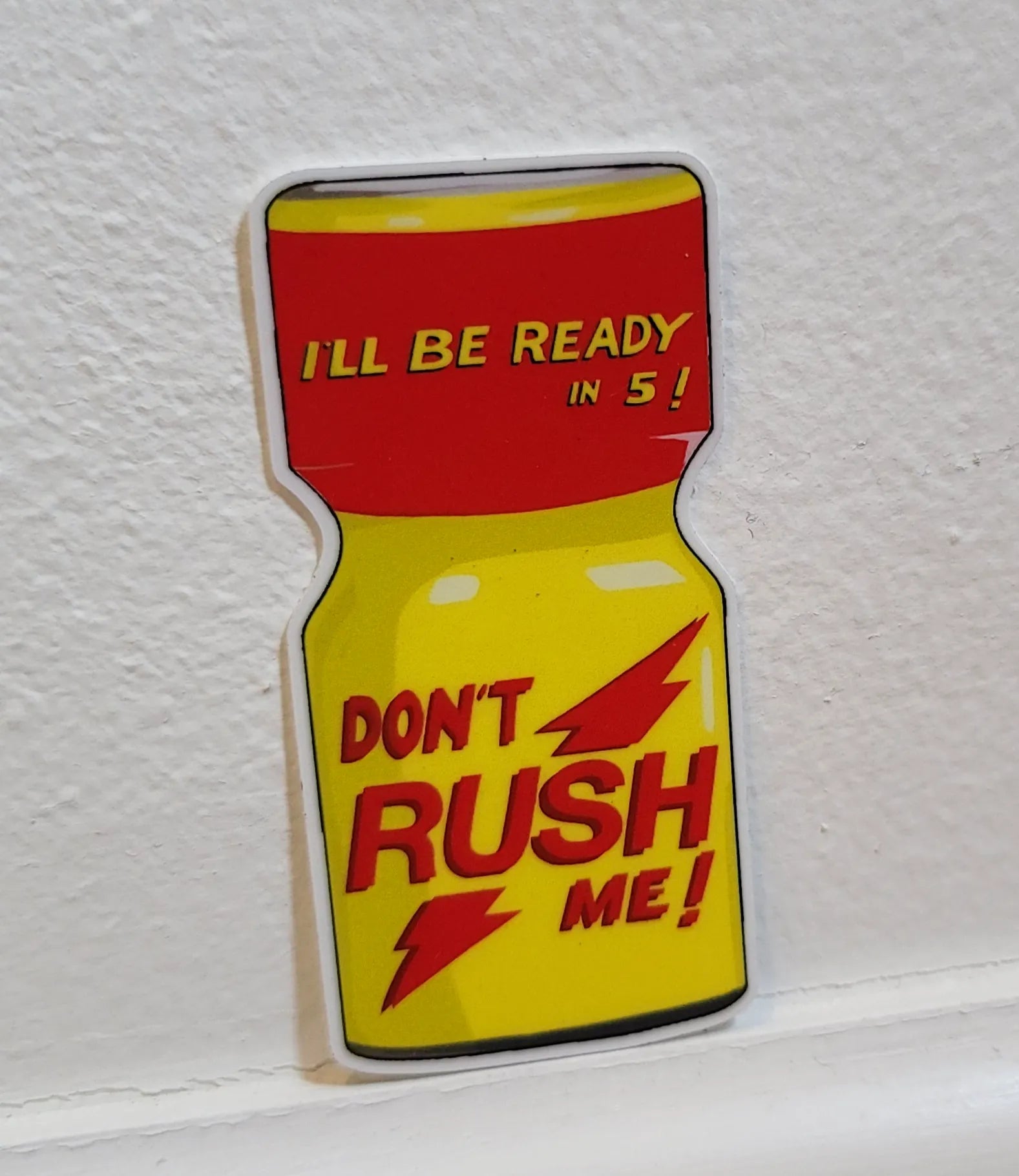 "Dont rush me" sticker leaning against wall