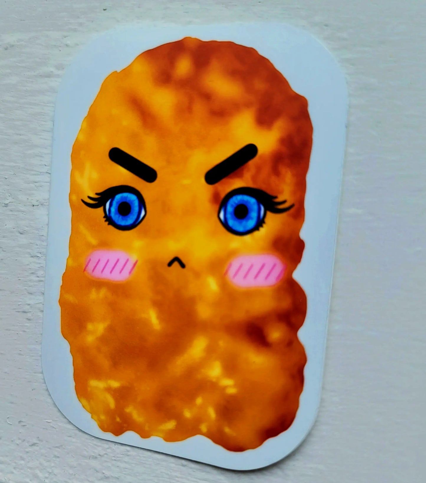 Grumpy chicken nugget sticker shown at a slight side-angle.